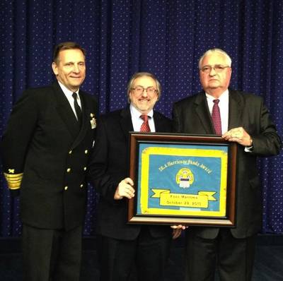 John Tirpak, far right, accepting the hand-embroidered flag award for Foss. The flag is made by a Philadelphia based woman-owned business in the spirit of Betsy Ross.