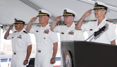 (Left to right) Navy Lt. Harlan Kimball, Comfort chaplain; Navy Rear Adm. Mark H. Buzby, commander, Military Sealift Command; Navy Capt. David K. Weiss, U.S. Navy Medical Corps; and Navy Capt. Kevin J. Knoop, commanding offer, Medical Treatment Facility, USNS Comfort, participate in Military Sealift Command hospital ship USNS Comfort's Medical Treatment Facility change of command ceremony May 25 in Baltimore. 