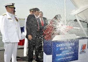 Marilla Waesche Pivonka (right), ship's sponsor, breaks a traditional bottle spraying the bow and platform guests at the christening of the Northrop Grumman-built U.S. Coast Guard National Security Cutter Waesche (WMSL 751). The ship is named for her grandfather, Adm. Russell Randolph Waesche, who served as the commandant of the U.S. Coast Guard from 1936 until 1946. Also on the platform are (left to right) U.S. Coast Guard Commandant Adm. Thad Allen; Mike Petters, vice president and president o