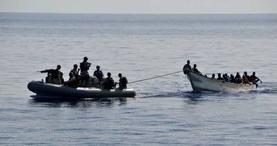 Members from the guided-missile cruiser USS Lake Champlain (CG 57) tow a disabled skiff carrying 52 Somali migrants. (U.S. Navy photo by Daniel Barker)
