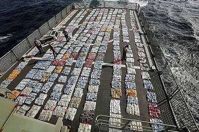 Members of HMAS Toowoomba account for and weigh 5.6 tonnes of cannabis resin on the flight deck of HMAS Toowoomba during Operation Manitou. Photo: James Whittle