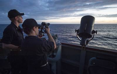 Midshipmen from the U.S. Merchant Marine Academy, fix the ship's position using a sextant aboard the Arleigh Burke-class guided-missile destroyer USS Benfold (DDG 65). (Photo: Deven Leigh Ellis / U.S. Navy)