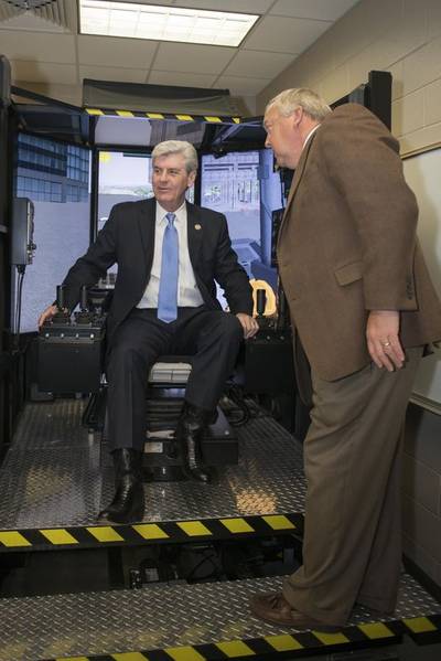 Mississippi Governor Phil Bryant tried his hand in a crane simulator during a tour of Ingalls Shipbuilding’s Maritime Training Academy. Also pictured is Larry Porter, a master trainer at Mississippi Gulf Coast Community College, which partners with Ingalls and the State of Mississippi in administering Ingalls’ apprenticeship program. Photo by Andrew Young/HII