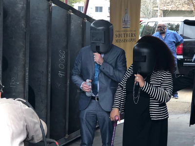 Ms. Aria Mason & Governor Bel Edwards watch as her initials are welded in a plate that will be affixed to the keel of R/V GILBERT R. MASON. (Photo courtesy of USM)