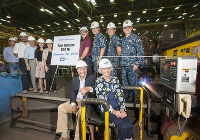 Paul and Nancy Ignatius (seated); also pictured (left to right): Lance Carnahan, Robert Velazquez, David Ignatius, Dr. Elisa Ignatius, Sarah Ignatius, George Nungesser, Capt. Mark Vandroff, Cmdr. Ben Wilder and Rear Adm. David J. Gale. (Photo by Lance Davis/HII)