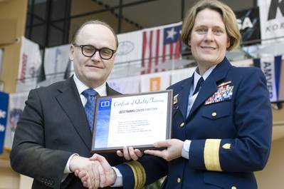 Nigel Cleave, CEO of Videotel, presenting a commemorative plaque to Rear Admiral Linda Fagan at CMA Shipping 2012. 