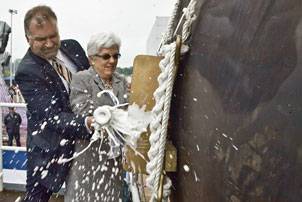 On June 5, 2010, Ellen Spruance Holscher and an unidentified man break a bottle of Champaign to christen the guided-missile destroyer Pre-Commissioning Unit (PCU) Spruance (DDG 111), during a ceremony at General Dynamics Bath Iron Works in Bath, Maine. Holscher is the ship's sponsor. Spruance is named after Holscher's grandfather, Adm. Raymond A. Spruance, the U.S. Navy commander at the Battle of Midway, fought June 4-7, 1942. (Photo courtesy of General Dynamics Bath Iron Works by D. Griggs)