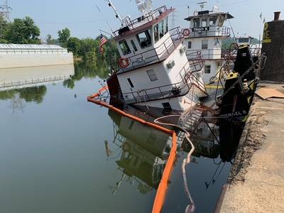 Containment boom limits diesel discharge from a partially sunken tugboat in Florence, Alabama, July 17, 2023. The Coast Guard and partner agencies responded to the fuel discharge, which has a maximum potential spill of 2,500 gallons. (U.S. Coast Guard photo, courtesy Marine Safety Detachment Nashville)