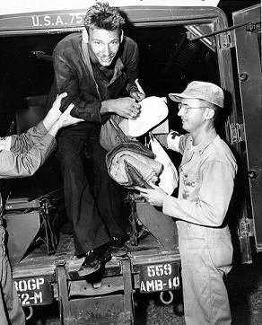 Operation Big Switch "Freedom -- Carrying a brand-new navy white hat, Zacheus A. Smith, Jr., hospital corpsman, third class, USN, ... climbs out of an ambulance at Freedom Village, Munsan, Korea, the processing center for returning POWs." (Official U.S. Navy Photograph, from the "All Hands" collection at the Naval Historical Center)