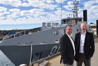 Patrick Gregg (Left) and David Singleton standing in front of a Guardian-class patrol Boat at Austal's Australian shipyard in Henderson, Western Australia. (Photo: Austal)
