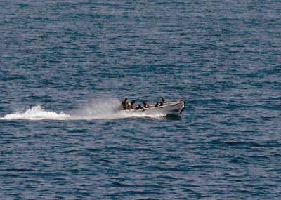 Pirates holding the MV Faina conduct a resupply Friday, Oct. 3, 2008 while under observation by a U.S. Navy ship. The Belize-flagged cargo ship, owned and operated by Kaalbye Shipping, Ukraine, is carrying a cargo of Ukrainian T-72 tanks and related military equipment. The ship was seized by pirates Sept. 25 and forced to proceed to an anchorage off the Somali Coast. U.S. Navy photo by Mass Communication Specialist 1st Class Eric L. Beauregard