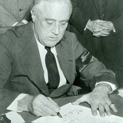 President Franklin D. Roosevelt signing into law the Lend-Lease Act. (Image courtesy of Library of Congress)