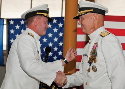 Rear Adm. T. K. Shannon (left) and Rear Adm. Mark Buzby congratulate each other during a change of command ceremony aboard the USNS Spearhead (JSHV 1). Shannon relieved Buzby as commander, Military Sealift Command.  (U.S. Navy Photo by Mass Communication Specialist Seaman Apprentice Jesse A. Hyatt)