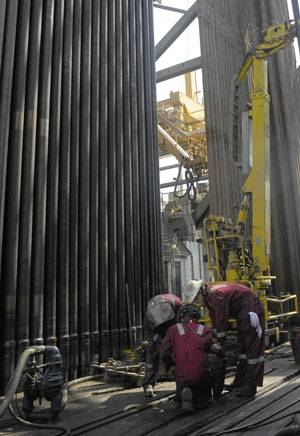 Roughnecks maneuver a section of drill collar into position on the drilling floor of Development Driller III, which drilled the relief well and pumped the cement to seal the Macondo well off the southern coast of Louisiana on Saturday, September 18, 2010. U.S. Coast Guard photo by Petty Officer 1st Class Thomas McKenzie