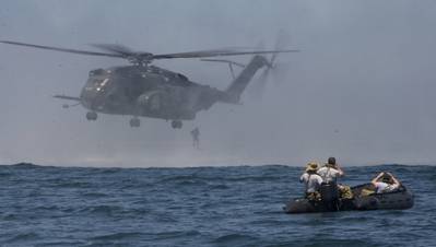 Royal Australian navy sailors act as safety observers as a Japanese Maritime Self Defense Force sailor jumps from an MH-53E Sea Dragon, attached to Mine Countermeasures Squadron 14, as part of aerial mine disposal training during the Southern California portion of the Rim of the Pacific 2016 Exercise. (U.S. Navy photo by Curtis D. Spencer)