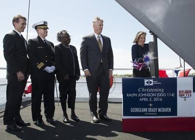 Ship Sponsor Georgeann McRaven christens DDG 114, the destroyer named for Medal of Honor recipient Ralph Johnson. Also pictured (left to right) are Assistant Secretary of the Navy Sean Stackley; Cmdr. Jason Patterson, the ship’s prospective commanding officer; Helen Richards, Ralph Johnson’s sister; and Ingalls Shipbuilding President Brian Cuccias. (Photo by HII)