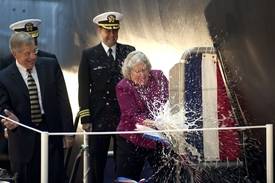 Ship's Sponsor Ellen Roughead performs the traditional honor of breaking a bottle of American sparkling wine across the hull of the submarine Minnesota (SSN 783). Also pictured (left to right) are Newport News Shipbuilding President Matt Mulherin and Cmdr. John Fancher, the ship's prospective commanding officer.