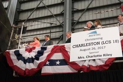 Ship's sponsor Charlotte Riley breaks a bottle of champagne across the bow during the christening ceremony for the littoral combat ship USS Charleston (LCS 18). (U.S. Navy photo by Armando Gonzales)