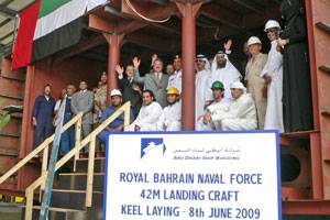 Staff Colonel Hasan Ahmed Mohammed, Head of the Planning Department, Royal Bahrain Naval Force and ADSB CEO Bill Saltzer with ADSB management and employees inside the first hull block constructed for the landing craft.