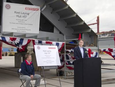 Steve Becker, vice president of Great Lakes Dredge & Dock Company, joins Victor Rhoades (seated), director and general manager of BAE Systems Southeast Shipyards, at a recent keel laying ceremony for the first of two dump scows under construction at BAE Systems’ Mobile, Alabama facility.