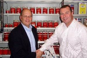 Steve Schultz (left) gets a farewell handshake from Neil Plowman (right), Interlux Global