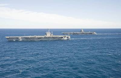 The aircraft carrier USS Enterprise (CVN 65) passes the aircraft carrier USS Harry S. Truman (CVN 75) in the Atlantic Ocean. (U.S. Navy photo by Naval Aircrewman (Tactical Helicopter) 3rd Class Matt Ballard/Released) 