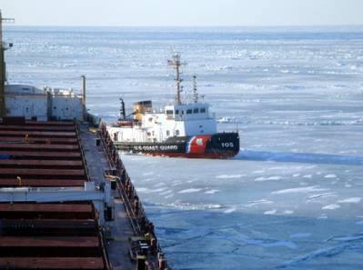 The crew of Coast Guard Cutter Neah Bay, homeported in Cleveland, works to keep the CSL Laurentien moving during an escort in eastern Lake Erie March 27, 2014. The crew experienced plate ice as thick as three feet and ice ridges as tall as eight feet. (U.S. Coast Guard photo courtesy of CSL Laurentien)