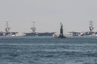 The Delaware SSN 791: The submarine Delaware returns to the Newport News Shipbuilding division following its first set of sea trials with three HII-built aircraft carriers visible in the distance at Norfolk Naval Station. Photo by Ashley Cowan/HII
