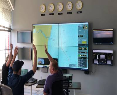  The shore-side commanders of Nellie Bly celebrate the milestone achievement from their posts in the company's Boston, Mass., USA, remote command station. (Photo: Sea Machines)