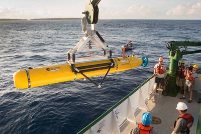 The team aboard the K-O-K research vessel prepare the Bluefin Robotics AUV for deployment. The vehicle was equipped with a Ranger 2 tracking transponder, visible towards the rear of the AUV