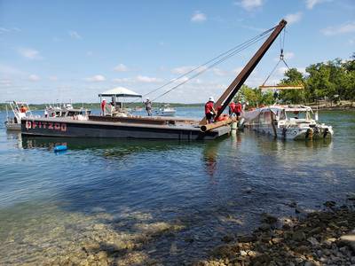 The U.S. Coast Guard oversees the removal of Stretch Duck 7 from Table Rock Lake in Branson, Mo., July 23, 2018. Missouri State Highway Patrol divers rigged the vessel, then a barge crane lifted it to the surface before it was towed to shore and loaded onto a flatbed trailer for transport to a secure facility. (U.S. Coast Guard photo by Lora Ratliff)