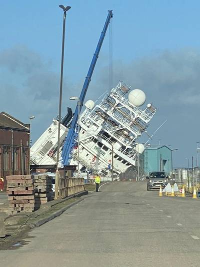 The U.S. Navy-owned research vessel Petrel has toppled over at Dales Marine's Leith dry dock facility in Edinburgh, Scotland.
The ship was previously a Subsea 7 offshore support vessel before being converted into a research vessel for late Microsoft co-founder Paul Allen's Vulcan Inc., who used the vessel to discover a number of long-lost shipwrecks. It was later sold to the U.S. Navy. (Photo: @ Tomafc83 / Twitter)