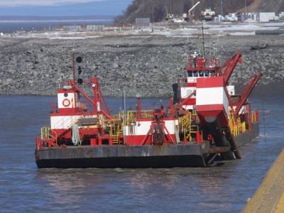 The Westport, a red and white hopper dredge operated by Manson Construction, dredges near the Port of Alaska on April 3, 2019. From May 1 to Nov. 1 each year, the U.S. Army Corps of Engineers removes built-up sediment from the seafloor near the Port of Alaska to maintain shipping channels and dock access. An estimated 50 percent of all goods entering Alaska come through this port. (Photo: U.S. Army)