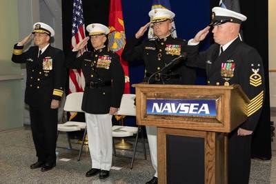 U.S. Navy Rear Adm. Thomas Anderson, (far left) Program Executive Officer Ships, U.S. Marine Corps. Brig. Gen. Robert Brodie, (left) Director of Expeditionary Warfare, Office of the Chief of Naval Operations, U.S. Marine Corps Col. Raymond Feltham, (right) Program Manager, Medium Landing Ship and U.S. Navy Command Master Chief James Timmerman, Program Executive Office, Ships, salute during an establishment ceremony for the Medium Landing Ship (LSM) Program Office at the Humphrey's Building on Wa