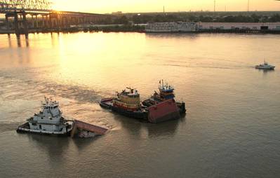 Three tugs hold up a barge that was split in two on the Mississippi, July 23, 2008. At about 2 a.m. that day the 600-foot tanker Tintomara and the Mel Oliver tug and barge collided and approximately 400,000 gallons of number six fuel oil spilled from the barge. (Photo: Chris Lippert / U.S. Coast Guard)