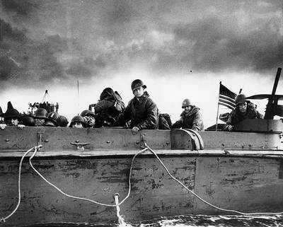 Troops and crewmen aboard a Coast Guard manned LCVP as it approaches a Normandy beach on "D-Day", June 6, 1944. (Photograph from the U.S. Coast Guard Collection in the U.S. National Archives.)