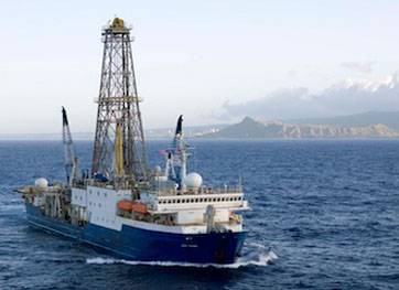 UH Professor Jonathan Snow will embark on a two-month journey aboard the JOIDES Resolution research vessel. Pictured here, the ship is shown departing Honolulu in 2009 for a prior expedition. (Credit: William Crawford, IODP/TAMU)