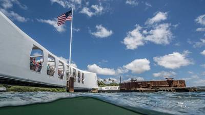 The Flag of the United States of America over the site of the USS Arizona Memorial. The findings underscore the USS Arizona’s dual role as a solemn memorial and a “living laboratory.” (Photo by Brett Seymour, NPS Submerged Resources Center)