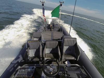 An unmanned rigid-hull inflatable boat operates autonomously during an Office of Naval Research (ONR)-sponsored demonstration of swarmboat technology held at Joint Expeditionary Base Little Creek-Fort Story. During the demonstration four boats, using an ONR-sponsored system called CARACaS (Control Architecture for Robotic Agent Command Sensing), operated autonomously during various scenarios designed to identify, trail or track a target of interest. (U.S. Navy photo by John F. Williams)