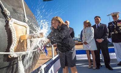 USS Rafael Peralta’s sponsor, Rosa Maria Peralta, breaks a bottle of champagne against the vessel’s bow (Photo: General Dynamics Bath Iron Works)