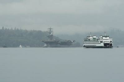 Washington State Ferry M/V Kaleetan passes by as USS Nimitz (CVN 68) transits Sinclair Inlet as it gets underway from Puget Sound Naval Shipyard. (U.S. Navy photo by Vaughan Dill)