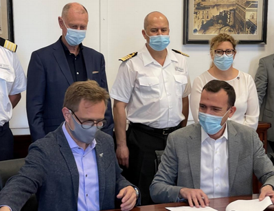 Windstar Cruises’ President Chris Prelog (on left) finishes signing handover documents for Star Legend at the Fincantieri shipyard in Palermo, Italy. (Photo: Windstar Cruises)