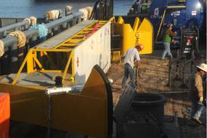 Workers load "Dutch arms" onto the platform supply vessel Seacor Washington, homeported in New Orleans, June 7, 2010. The skimming system, purchased from Holland, includes infrared cameras that monitor the depth of the oil and a vacuum system to retrieve the oil. U.S. Coast Guard photo by Petty Officer 3rd Class Ann Marie Gorden. 