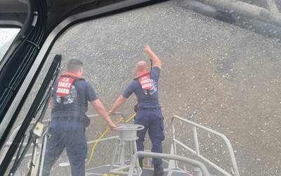 A Coast Guard boat crew attempts to throw a hammer at the hull of the Seacor Power in an attempt to make contact with potential survivors inside the vessel. (U.S. Coast Guard photo courtesy of Coast Guard Station Grand Isle)