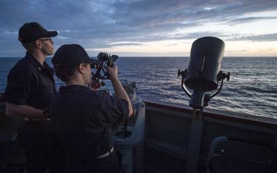 Midshipmen from the U.S. Merchant Marine Academy, fix the ship's position using a sextant aboard the Arleigh Burke-class guided-missile destroyer USS Benfold (DDG 65). (Photo: Deven Leigh Ellis / U.S. Navy)
