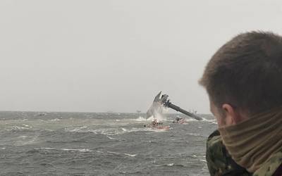 The crew of the Coast Guard Cutter Glenn Harris pulls a person from the water April 13, 2021 after a 175-foot commercial lift boat Seacro Power capsized 8 miles south of Port Fourchon, La. (U.S. Coast Guard photo courtesy of Coast Guard Cutter Glenn Harris)