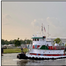 The towing vessel Baylor J. Tregre (left) is pictured on an unknown date and the ocean barge Marmac 27 is pictured after the casualty. (Source: Trinity Towing LLC)