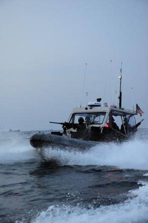 A boat crew from U.S. Coast Guard Port Security Unit (PSU) 313, from Everett, Wash., conducts a security patrol in a 4th generation, 32-foot transportable security boat (TSB) off the coast of Dogu beach in support of exercise Foal Eagle, April 21, 2013. PSU 313 along with Republic of Korea military forces, provided 24-hour water-side and shore-side force protection during Foal Eagle, a Combined/Joint Logistics Over-the-Shore Exercise (C/JLOTS). (U.S. Coast Guard photo by Petty Officer 2nd Class 