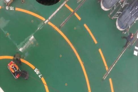 A Coast Guard Air Station Kodiak MH-60 Jayhawk helicopter crew medevacs an injured man from the South Korean research icebreaker Araon 250 miles north of Barrow, Alaska, Aug. 20, 2014. (USCG video)