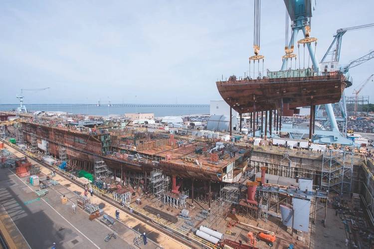 A crane moves the lower stern into place on the nuclear-powered aircraft carrier USS John F. Kennedy (CVN 79) at Huntington Ingalls Shipbuilding in Newport News, Va. John F. Kennedy is the second Gerald R. Ford-class aircraft carrier which is now 50 percent structurally complete. (U.S. Navy photo)